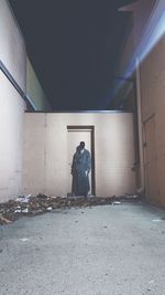 Man sitting in abandoned building