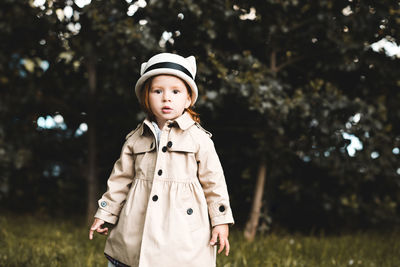 Portrait of cute girl standing at park