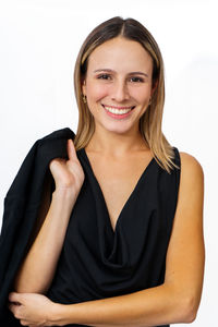 Portrait of young woman standing against white background