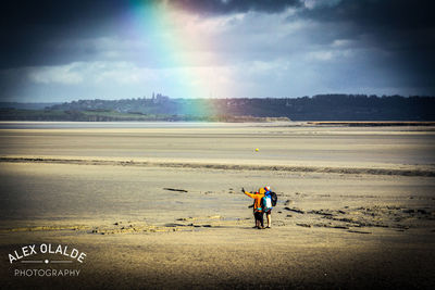 Man standing on beach against sky