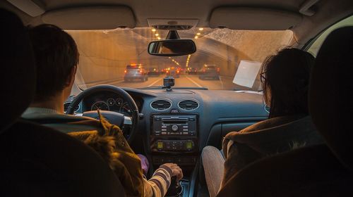 Rear view of people sitting in car