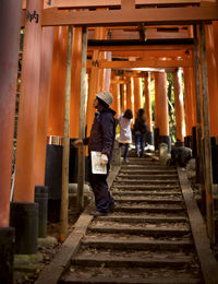 People walking on staircase at temple