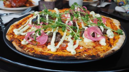 Close-up of pizza served on table