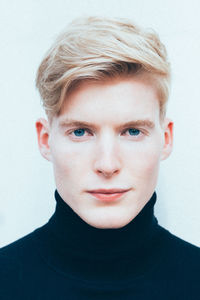 Close-up portrait of young man against white background