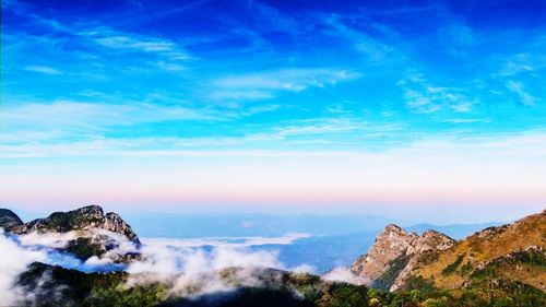 Panoramic view of mountains against blue sky