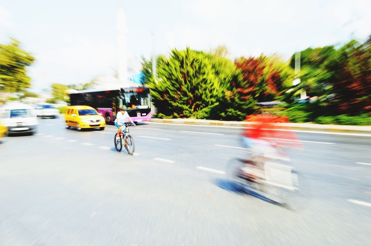 transportation, land vehicle, mode of transport, car, road, street, tree, on the move, the way forward, travel, stationary, parked, motorcycle, road marking, parking, motion, sky, vehicle, outdoors, day