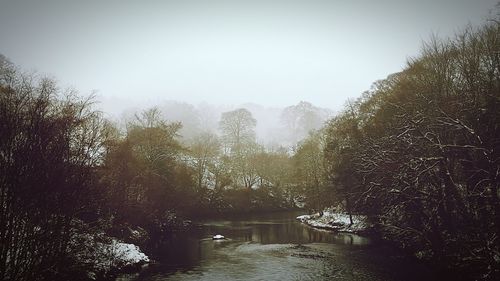 Scenic view of river in foggy weather