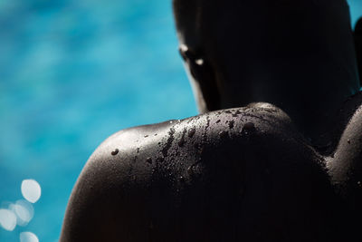 Cropped image of wet shirtless man