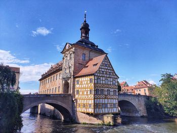 Arch bridge over river amidst buildings in bamberg