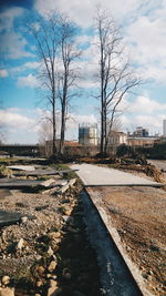 Empty road along buildings