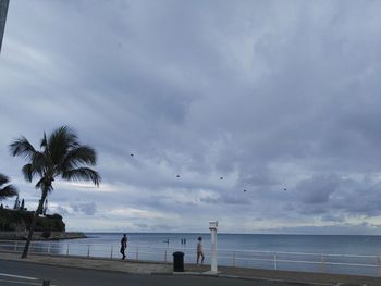 Scenic view of beach against cloudy sky