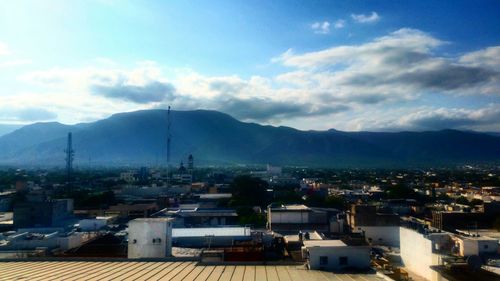 Cityscape with mountain range in background