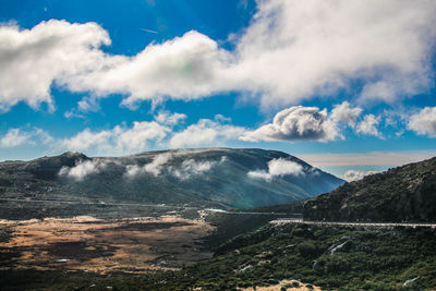 Scenic view of mountains against cloudy sky