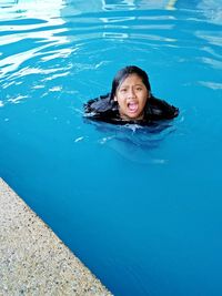 Portrait of young woman in swimming pool
