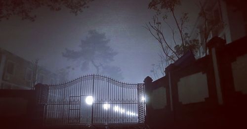 Low angle view of illuminated building against sky at night