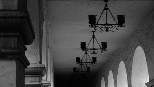 Low angle view of illuminated lanterns hanging by building