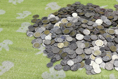 High angle view of coins on grass