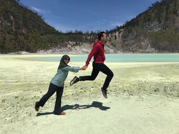 Full length of couple at beach