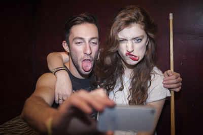 Young couple taking selfies on a cell phone