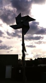 Low angle view of silhouette built structure against sky