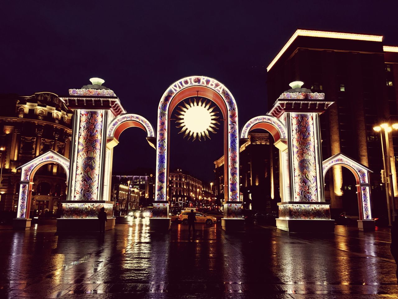 LOW ANGLE VIEW OF ILLUMINATED FOUNTAIN AT NIGHT