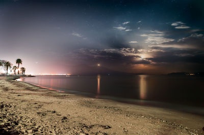 Scenic view of beach against sky at night