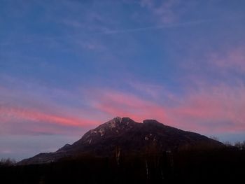 Scenic view of silhouette mountains against sky at sunset