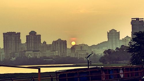 Buildings in city at sunset