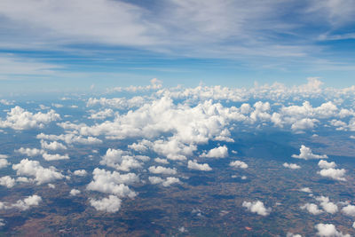 Aerial view of clouds over landscape against sky