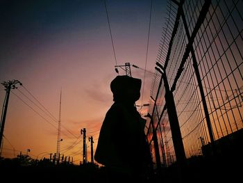 Low angle view of silhouette man against sky during sunset