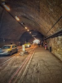 Woman moving in illuminated underground walkway