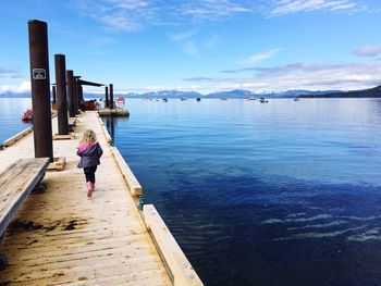 Woman standing on pier