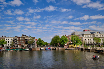 Amsterdam, netherlands, panoramic view across the amstel river with bridge over nieuwe herengracht. 