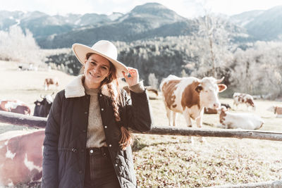 Portrait of young woman standing on field