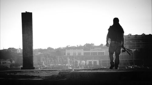 Full length of woman standing by railing