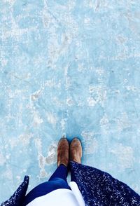 Low section of man standing in swimming pool