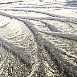 High angle view of tire tracks on sand