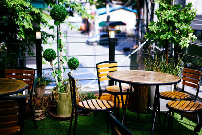 Empty wooden tables and chairs arranged at restaurant