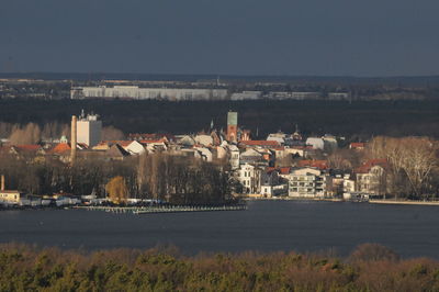 Townscape by sea against sky in city