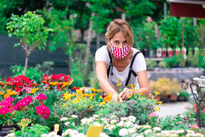 Full length of woman with multi colored flowers