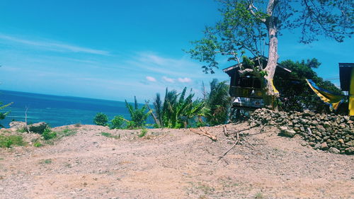 Scenic view of trees against blue sky