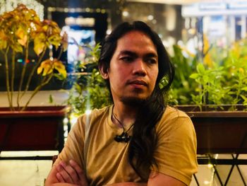 Portrait of young man looking away at restaurant