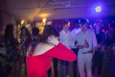 People standing in illuminated nightclub