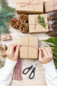 High angle view of woman packing gift box