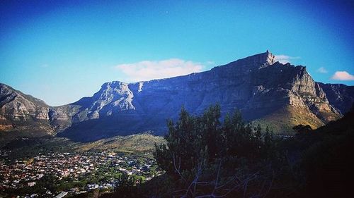 Scenic view of mountains against blue sky