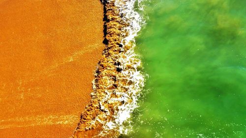 High angle view of sea waves splashing on shore