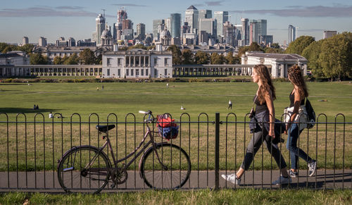 Bicycles in city against sky