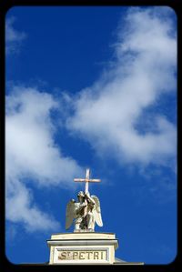 Low angle view of sculpture against cloudy sky