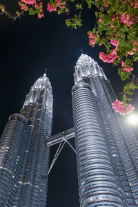 Low angle view of buildings against sky at night