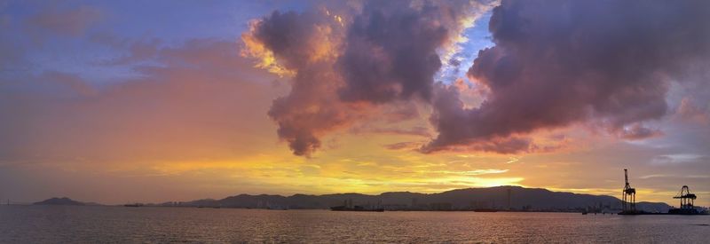 Scenic view of dramatic sky over sea during sunset